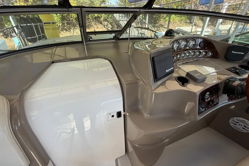 Slide: The Image of 2002 Four Winns 328 Vista boat cockpit with Raymarine navigation system and control panel. - 22