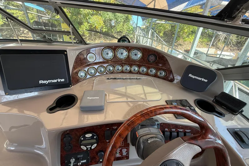 Slide: The Image of 2002 Four Winns 328 Vista boat dashboard with Raymarine navigation system. - 25