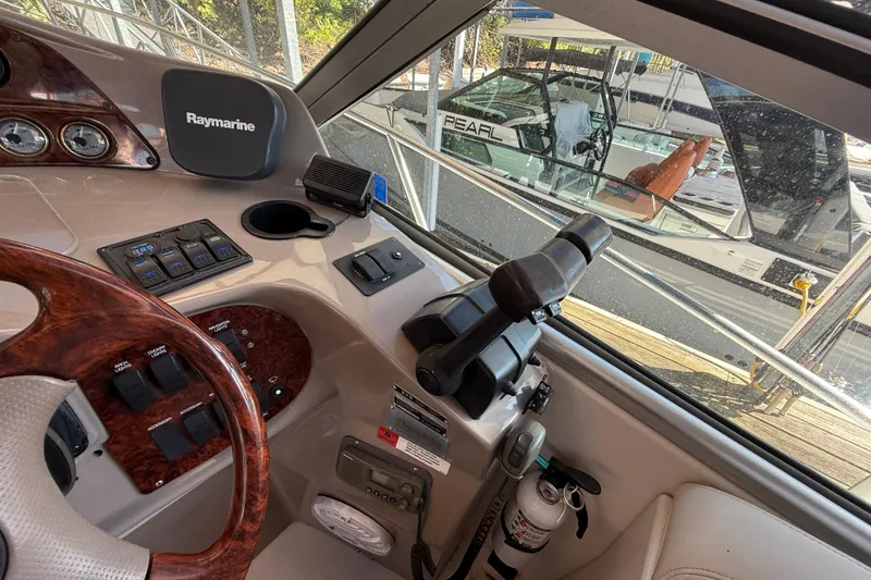 Slide: The Image of 2002 Four Winns 328 Vista boat cockpit with steering wheel and control panel. - 26