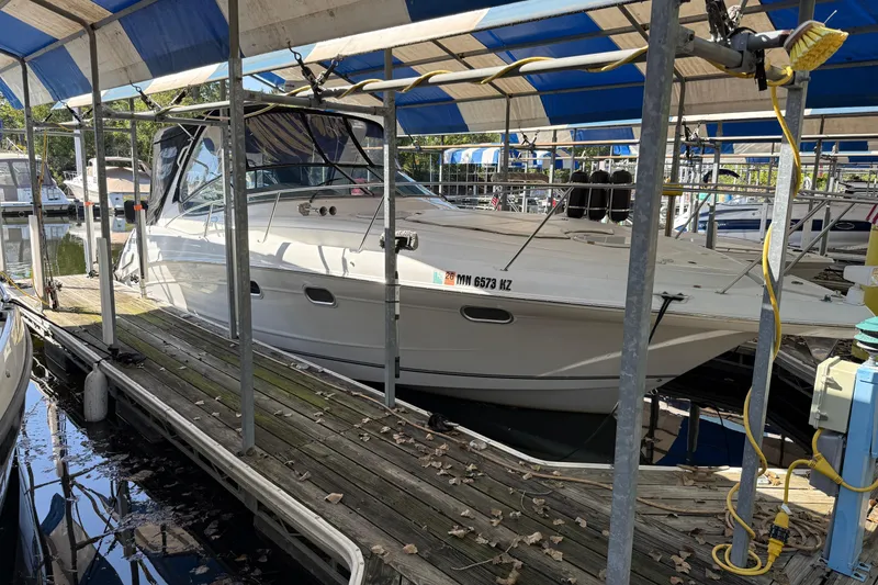 Slide: The Image of 2002 Four Winns 328 Vista boat docked under blue canopy. - 3