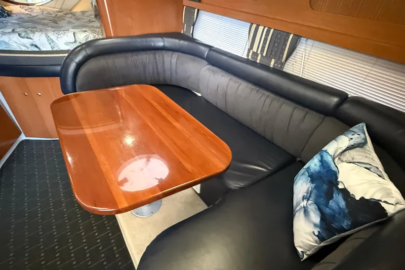 Slide: The Image of Luxurious interior of 2002 Four Winns 328 Vista with elegant seating and wooden table. - 34
