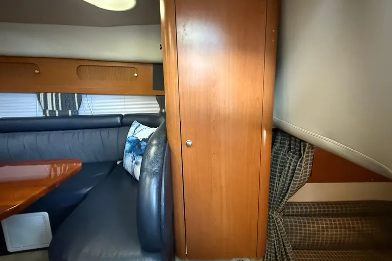 Slide: The Image of Interior of 2002 Four Winns 328 Vista boat with wood cabinetry and cushioned seating. - 35