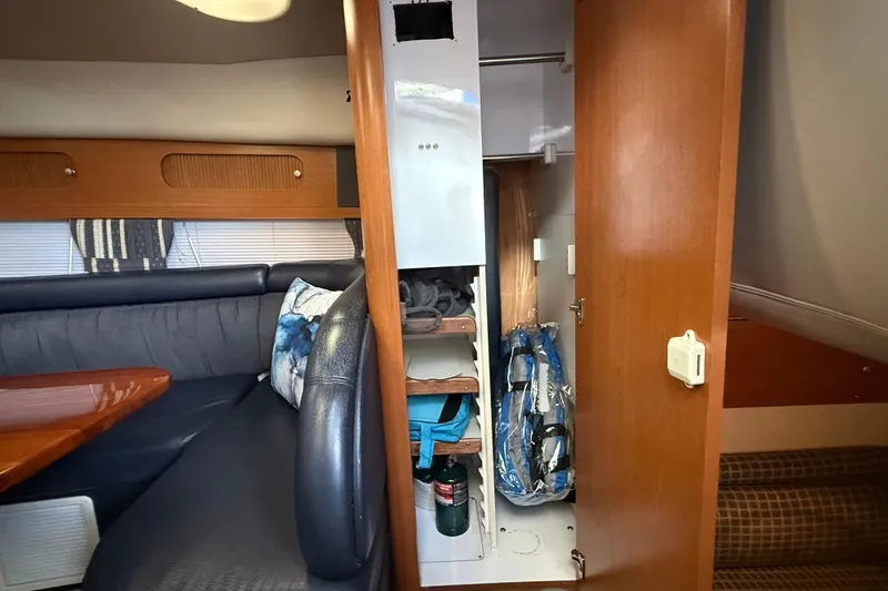 Slide: The Image of Interior of 2002 Four Winns 328 Vista boat with seating and storage area. - 36