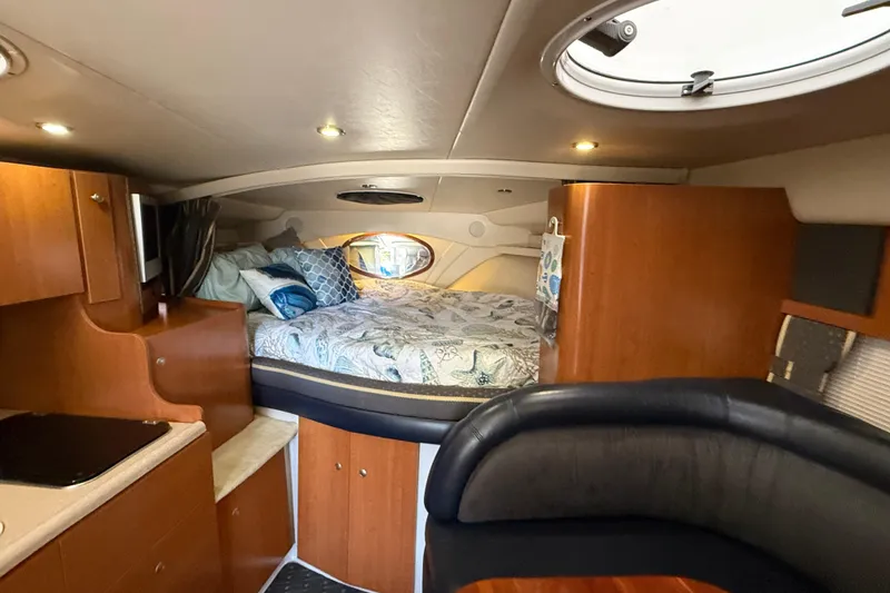 Slide: The Image of Luxurious interior of 2002 Four Winns 328 Vista boat with cozy bed and elegant wood finish. - 37