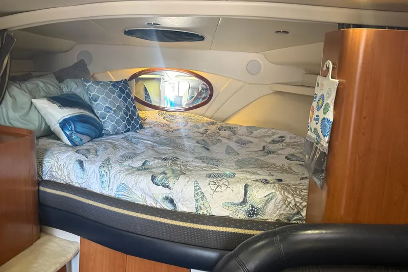 Slide: The Image of Luxurious cabin interior of 2002 Four Winns 328 Vista with nautical-themed bedding. - 38