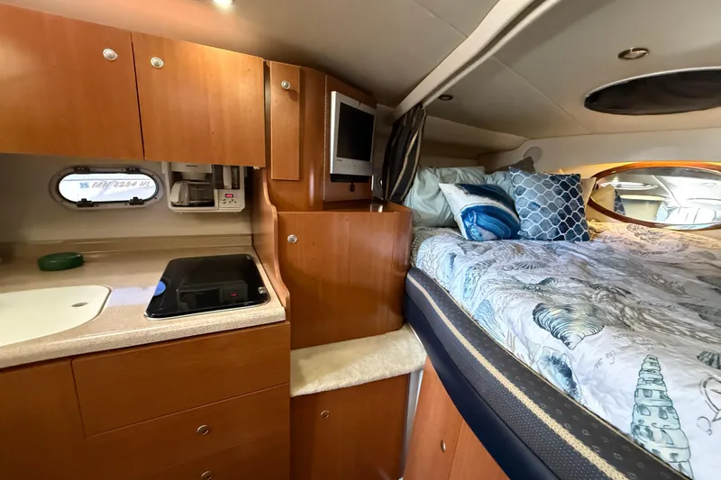 Slide: The Image of 2002 Four Winns 328 Vista cabin interior with bed, kitchenette, and cozy decor. - 39