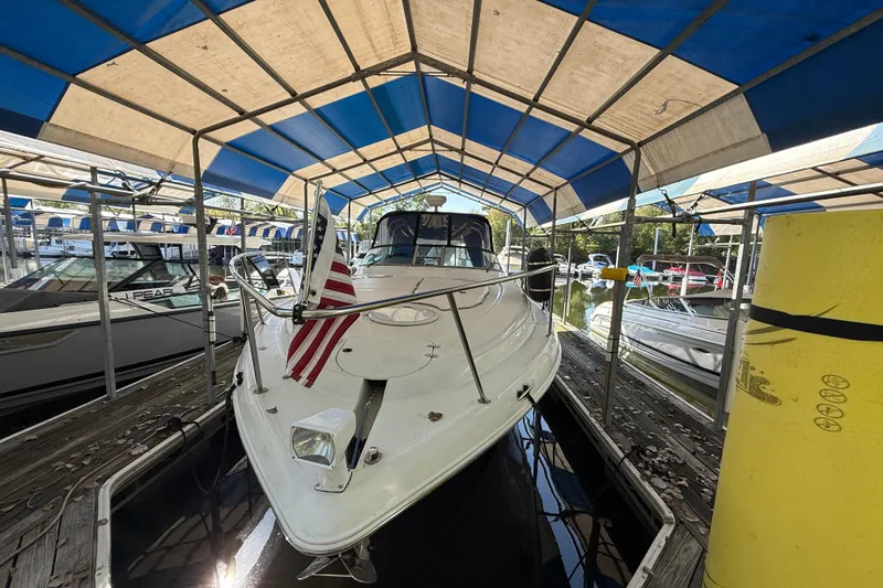 Slide: The Image of 2002 Four Winns 328 Vista boat docked under blue canopy at marina. - 4
