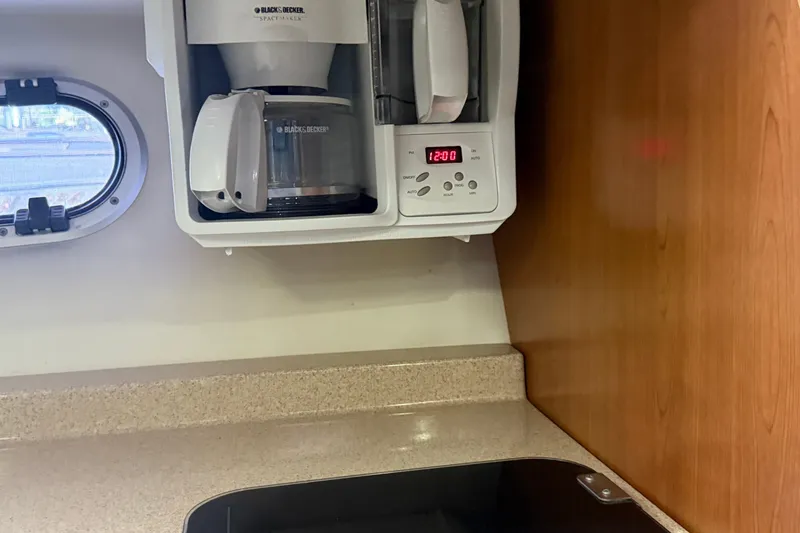 Slide: The Image of 2002 Four Winns 328 Vista kitchen with coffee maker and countertop. - 44