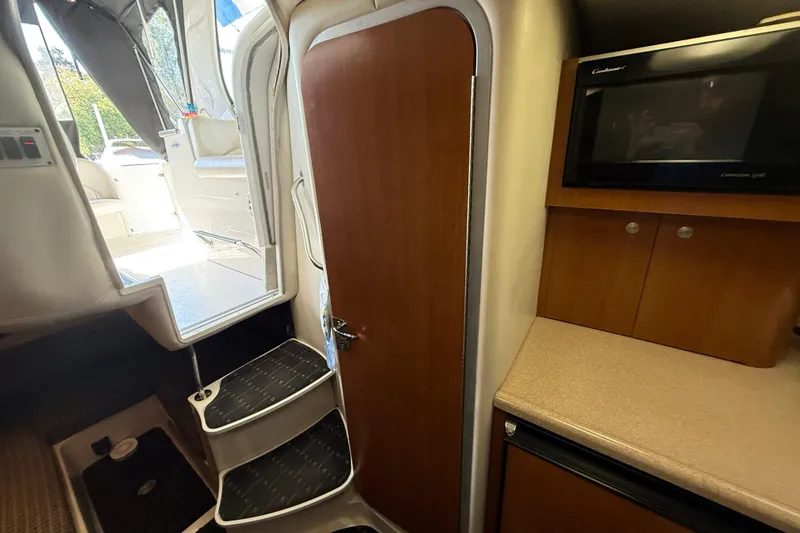 Slide: The Image of Interior view of 2002 Four Winns 328 Vista boat, featuring stairs and kitchenette area. - 46