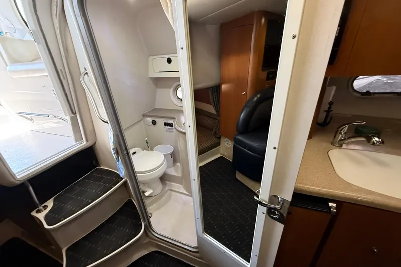 Slide: The Image of Interior of 2002 Four Winns 328 Vista boat, featuring bathroom and seating area. - 47