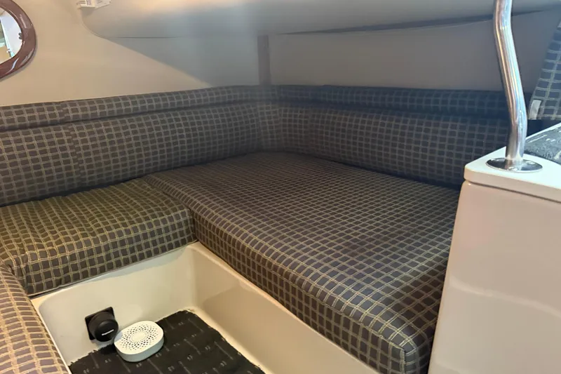 Slide: The Image of 2002 Four Winns 328 Vista cabin interior with checkered seating. - 51
