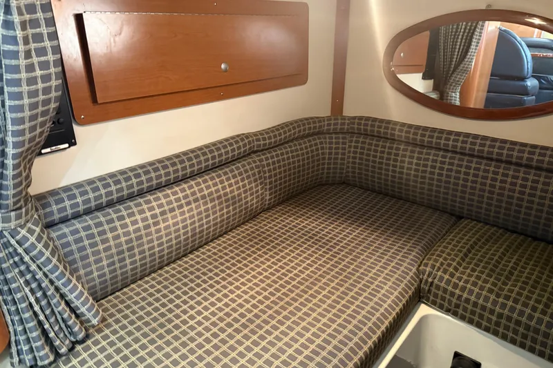 Slide: The Image of Interior cabin of 2002 Four Winns 328 Vista with checkered upholstery and wooden accents. - 52