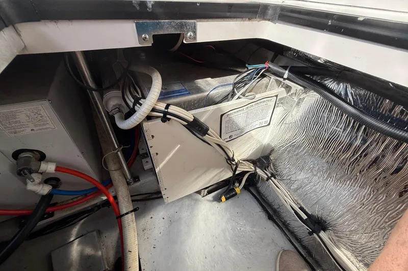 Slide: The Image of Engine compartment of a 2002 Four Winns 328 Vista boat, showing wiring and components. - 62