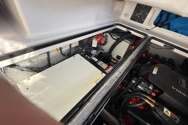 Slide: The Image of Engine compartment of a 2002 Four Winns 328 Vista boat, featuring Volvo components. - 65