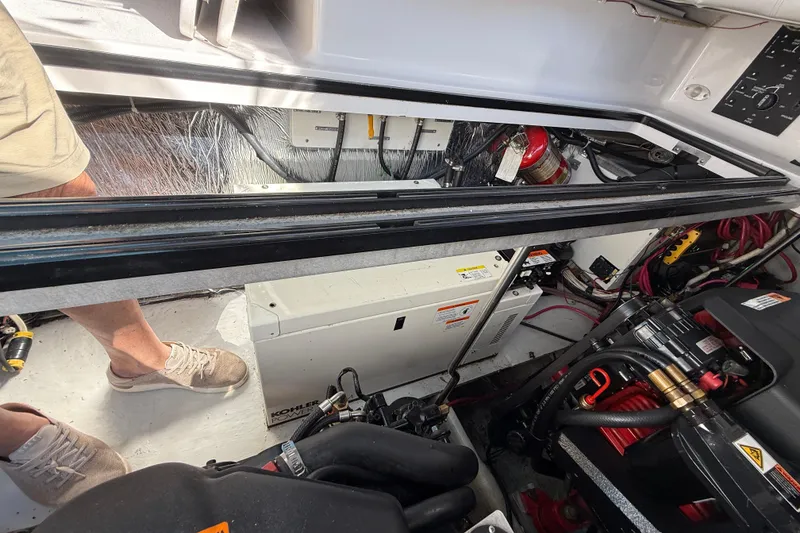 Slide: The Image of Engine compartment of a 2002 Four Winns 328 Vista boat, showing mechanical components. - 66