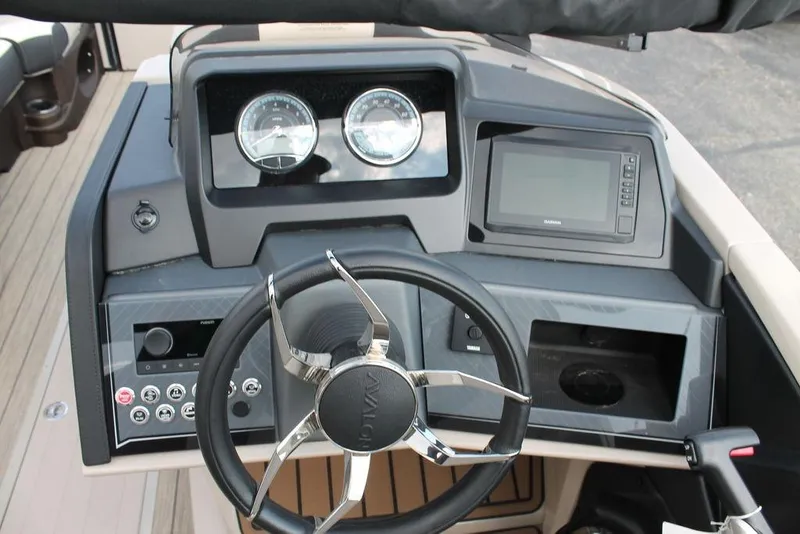 Slide: The Image of 2026 Avalon Catalina Cruise 23' boat dashboard with steering wheel and navigation system. - 16