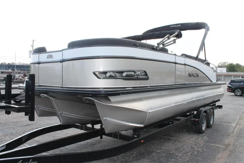 Slide: The Image of 2026 Avalon Catalina Cruise 23' pontoon boat on trailer, sleek silver design. - 3