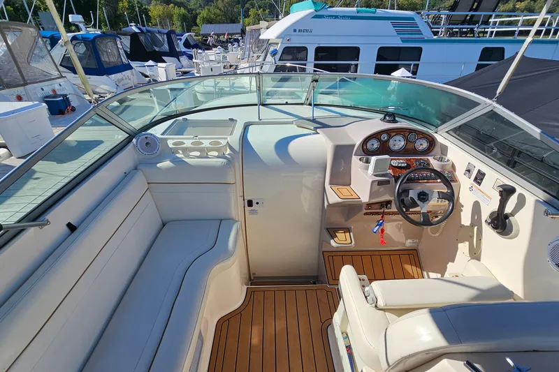 Slide: The Image of 2004 Rinker 270 Fiesta Vee boat interior with helm, seating, and dashboard controls. - 14