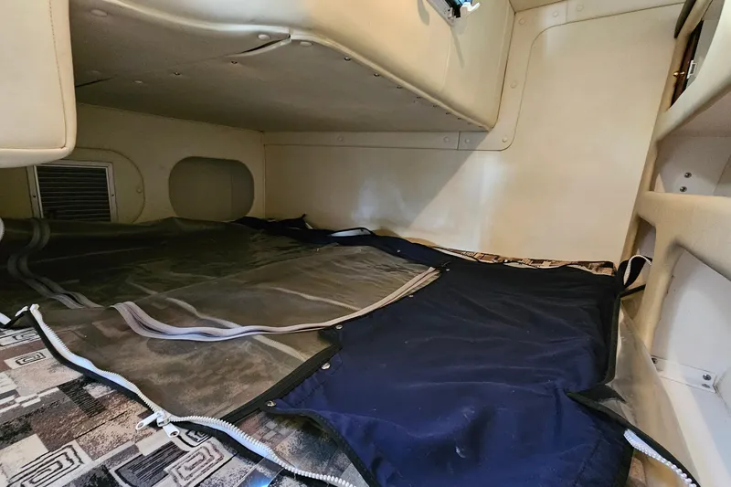 Slide: The Image of 2004 Rinker 270 Fiesta Vee cabin interior with sleeping area and storage. - 24