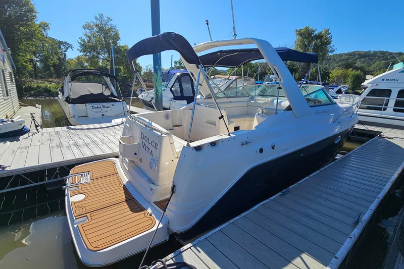 Slide: The Image of 2004 Rinker 270 Fiesta Vee boat docked at marina under clear blue sky. - 3