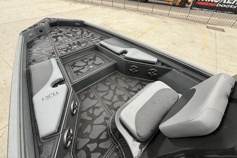 Slide: The Image of 2023 Excel 220 Bay Pro boat interior with stylish seating and storage compartments. - 10