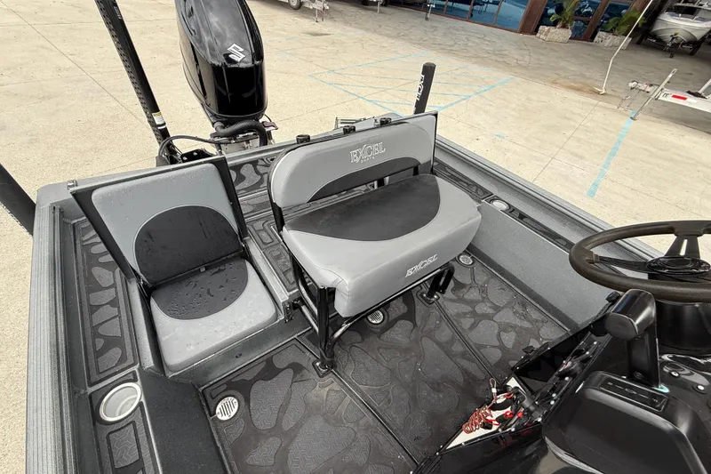 Slide: The Image of 2023 Excel 220 Bay Pro boat interior with seating and steering wheel. - 12