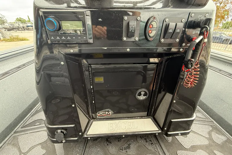 Slide: The Image of 2023 Excel 220 Bay Pro boat console with controls and audio system. - 16