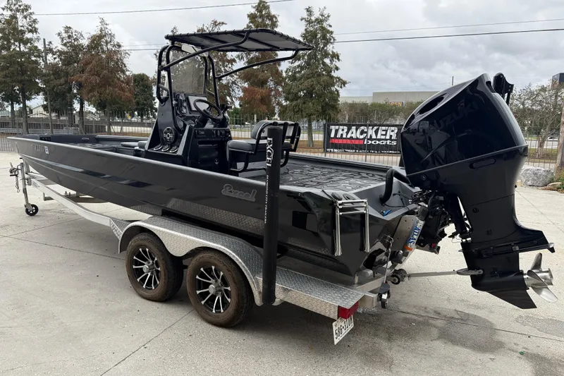 Slide: The Image of 2023 Excel 220 Bay Pro boat on trailer with powerful outboard motor. - 5