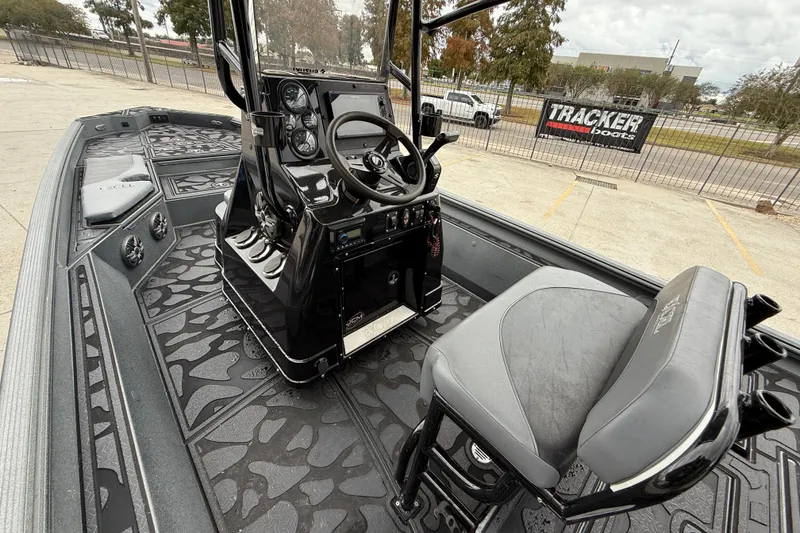 Slide: The Image of 2023 Excel 220 Bay Pro boat interior with steering console and seating. - 9