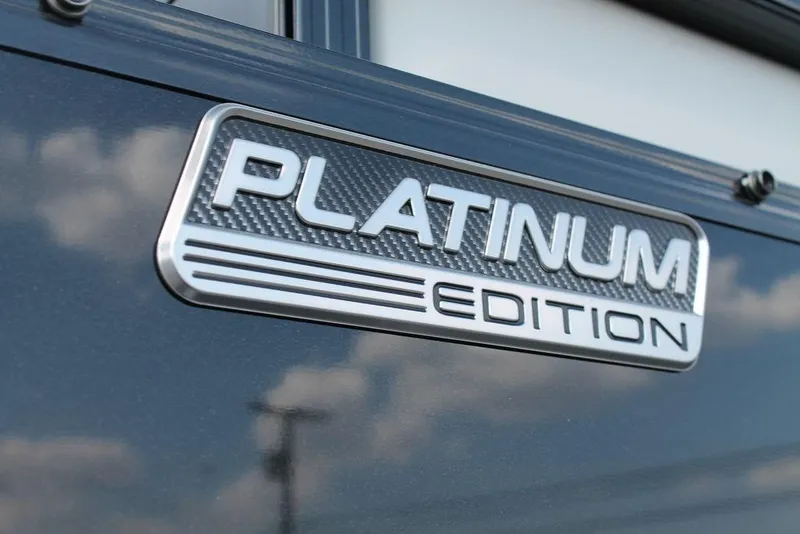 Slide: The Image of 2026 Avalon LSZ ELITE - 23 pontoon boat on trailer, sleek design, outdoor setting. - 5