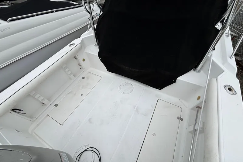 Slide: The Image of 1999 Wellcraft 22 Coastal Walkaround O/B boat deck with storage compartments. - 7