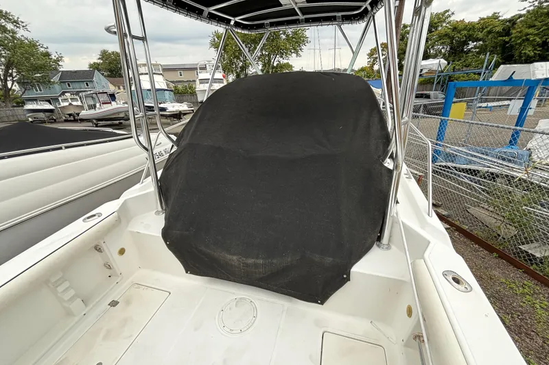 Slide: The Image of 1999 Wellcraft 22 Coastal Walkaround O/B boat with covered console, docked in a marina. - 8