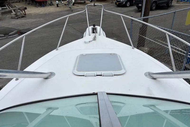 Slide: The Image of 1999 Wellcraft 22 Coastal Walkaround boat deck with railing and hatch. - 9