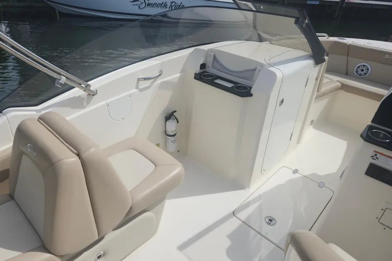 Slide: The Image of 2022 Scout 215 Dorado boat interior with beige seating and console. - 11