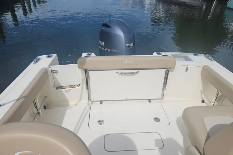 Slide: The Image of 2022 Scout 215 Dorado boat interior with Yamaha 150 engine on calm water. - 12