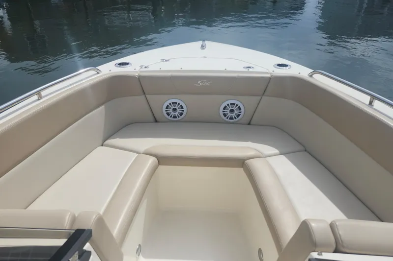 Slide: The Image of 2022 Scout 215 Dorado boat interior with beige seating and water view. - 14