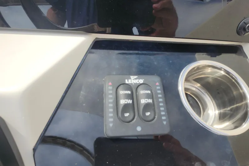Slide: The Image of Control panel of 2022 Scout 215 Dorado boat with Lenco trim tab switches. - 15