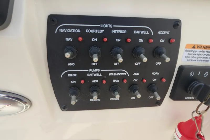 Slide: The Image of Control panel of a 2022 Scout 215 Dorado boat with various switches and labels. - 17