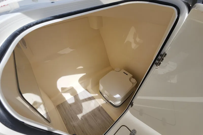 Slide: The Image of 2022 Scout 215 Dorado boat interior with compact marine toilet. - 22