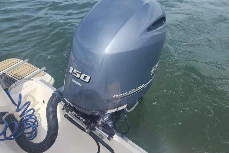 Slide: The Image of Yamaha 150 outboard motor on 2022 Scout 215 Dorado boat in water. - 24