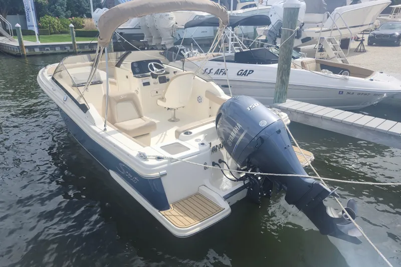 Slide: The Image of 2022 Scout 215 Dorado boat docked with Yamaha outboard motor. - 4