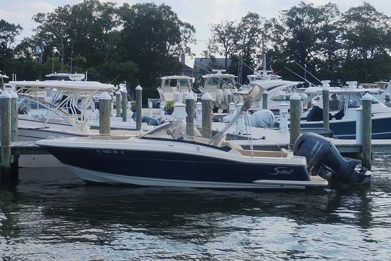 Slide: The Image of 2022 Scout 215 Dorado boat docked at a marina with other vessels. - 5