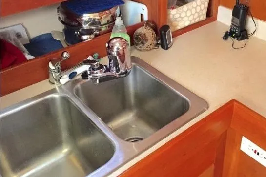 Slide: The Image of 2003 Mainship 34 PILOT kitchen sink with faucet and countertop accessories. - 17