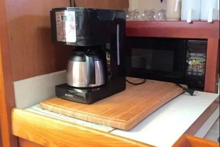 Slide: The Image of Coffee maker and microwave on Mainship 34 Pilot 2003 boat kitchen counter. - 18