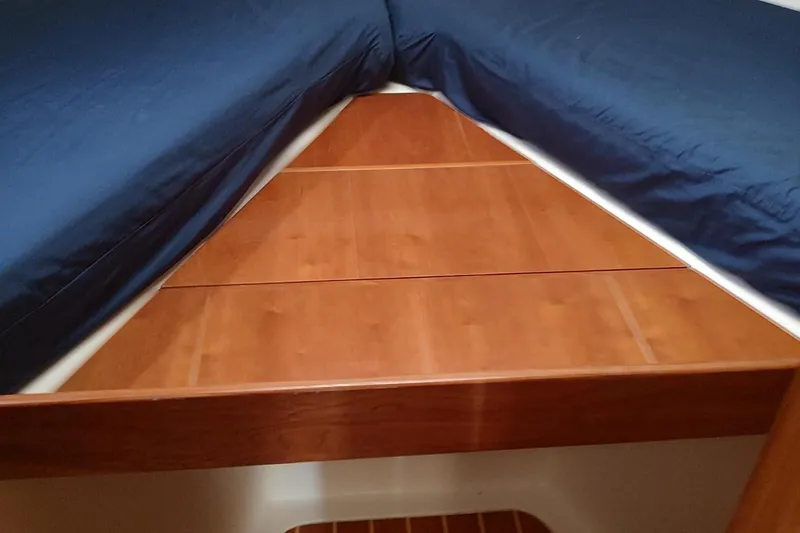 Slide: The Image of 2003 Mainship 34 PILOT cabin interior with blue bedding and wooden accents. - 20