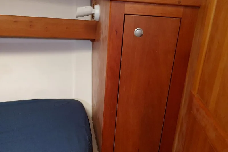 Slide: The Image of Wooden interior of 2003 Mainship 34 PILOT boat with blue cushion and cabinet. - 23