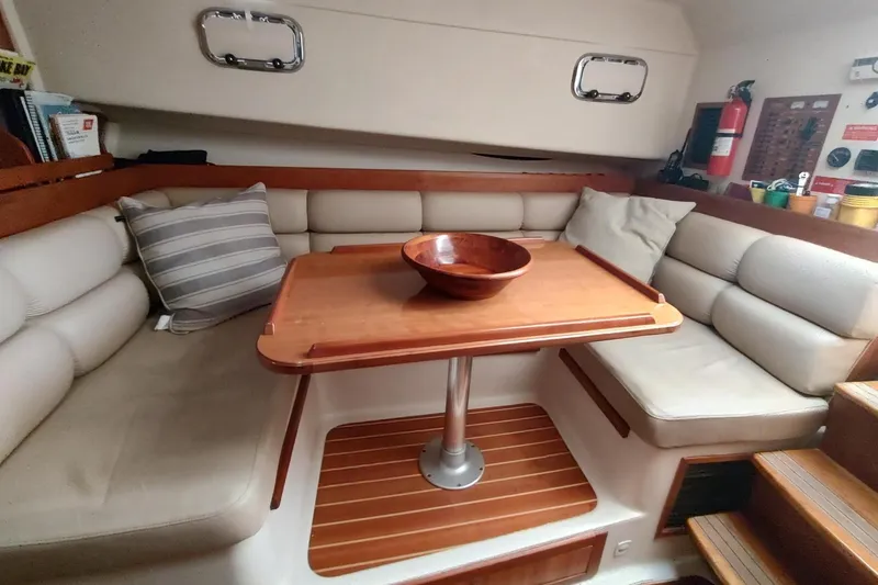 Slide: The Image of Interior of 2003 Mainship 34 PILOT with cozy seating and wooden table. - 29