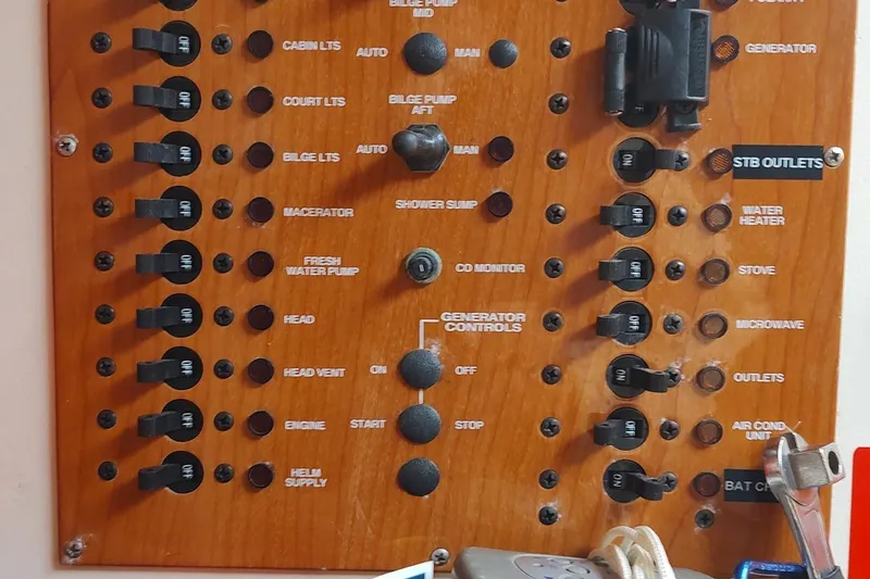 Slide: The Image of Control panel of a 2003 Mainship 34 PILOT boat with labeled switches and controls. - 31