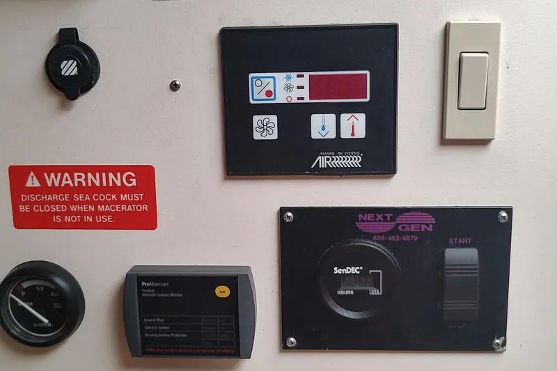 Slide: The Image of Control panel of a 2003 Mainship 34 PILOT boat with warning labels and switches. - 32