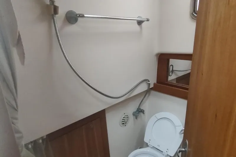 Slide: The Image of Bathroom interior of 2003 Mainship 34 PILOT boat with toilet and showerhead. - 35